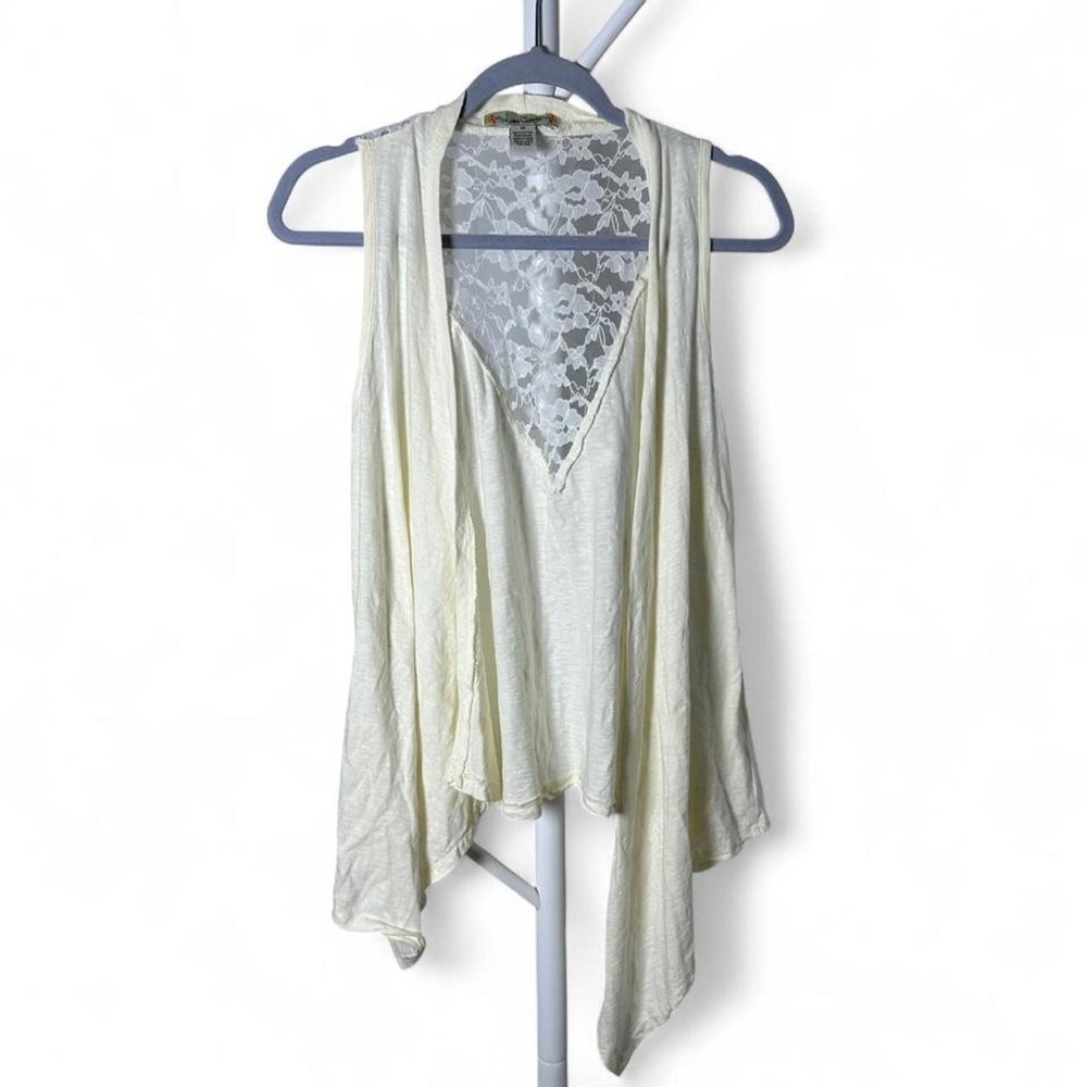 Cream lace open front cardigan with asymmetrical hem and sheer lace back.